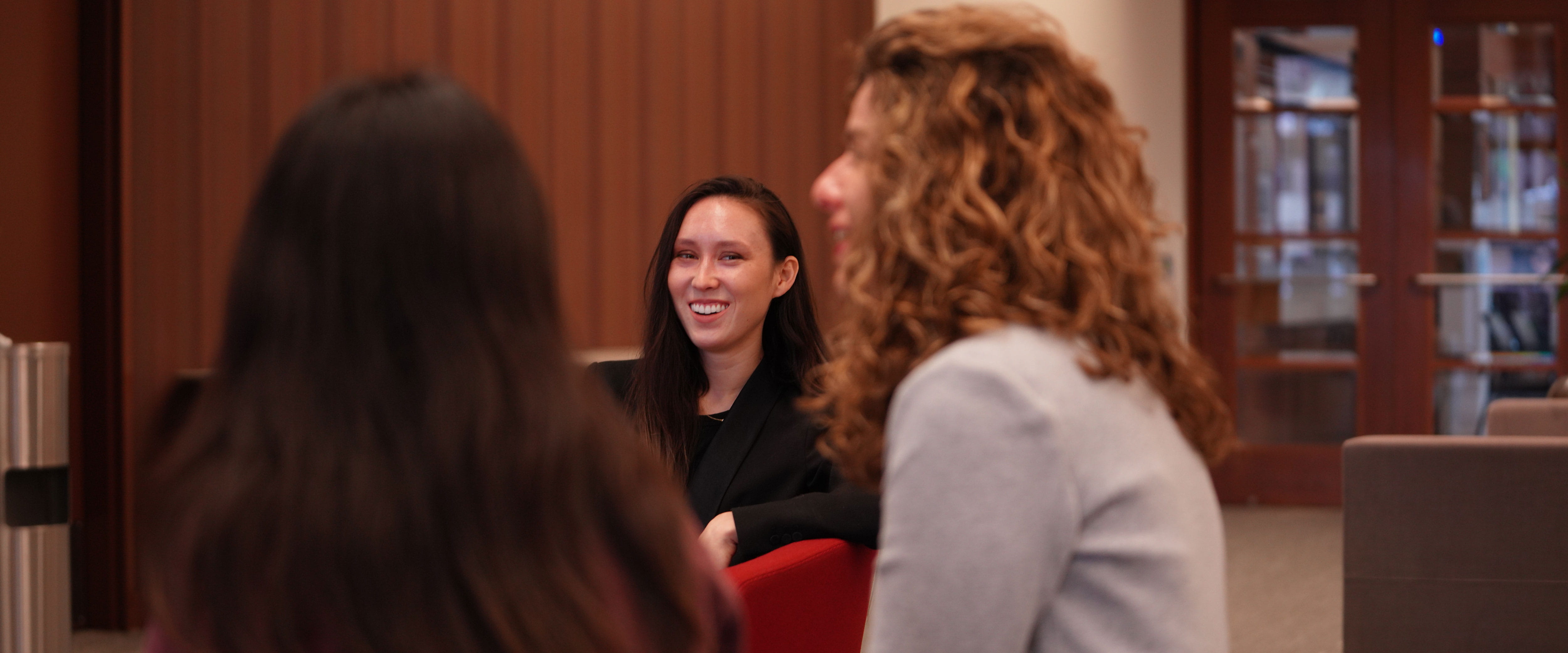 Booth students conversing inside of Gleacher Center