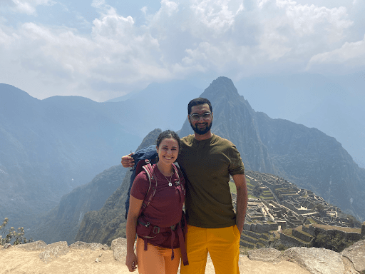 Daniella Pombo and dear friend and fellow Boothie Ananth Sriram posing in front of mountains 