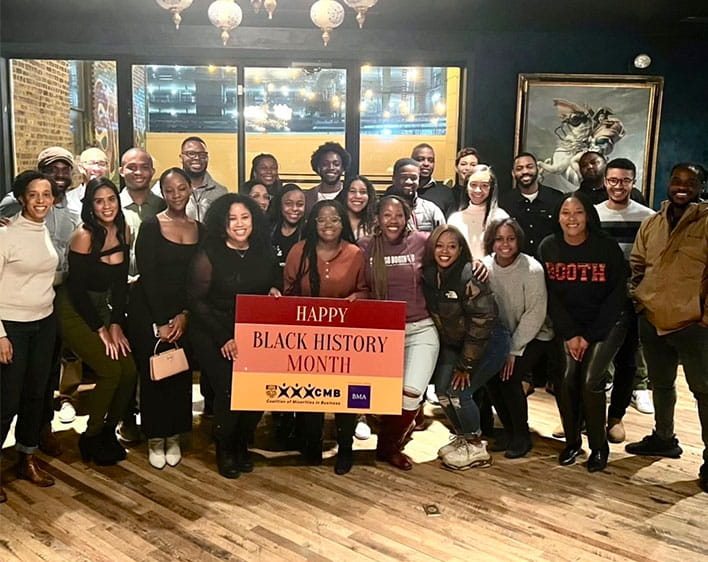 Boothies posing with "Happy Black History Month CMB" sign
