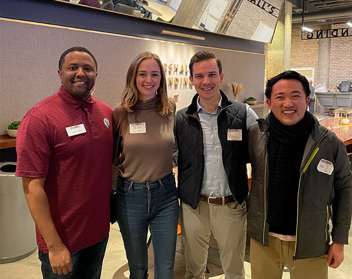 members of the Booth Finance Club smiling together indoors 