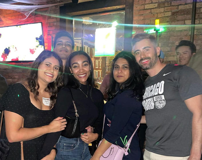 Five Boothies smiling in group photo taken indoors