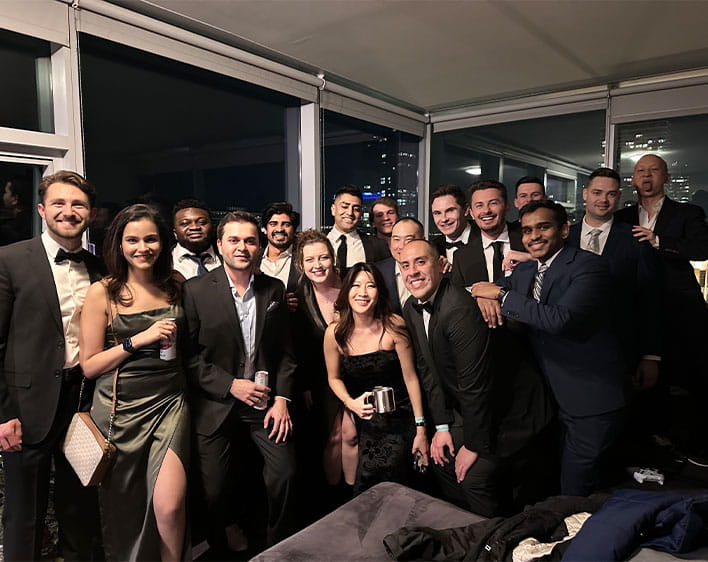 Group of Boothies photographed together, including Enrique Palomo in formal attire