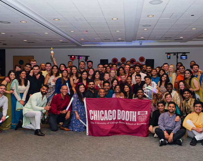 group photo of Boothies holding Booth flag