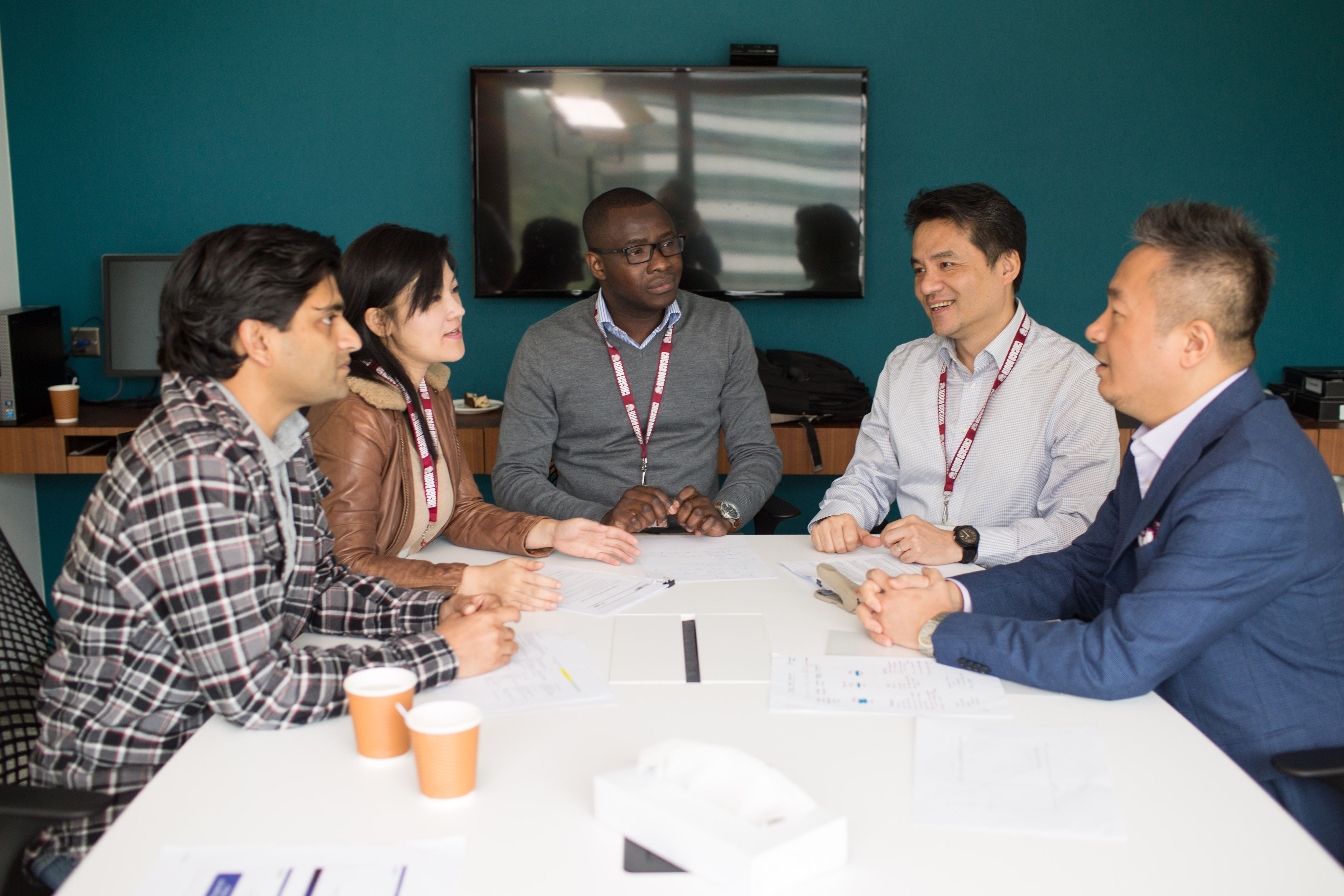Booth students work together around a table