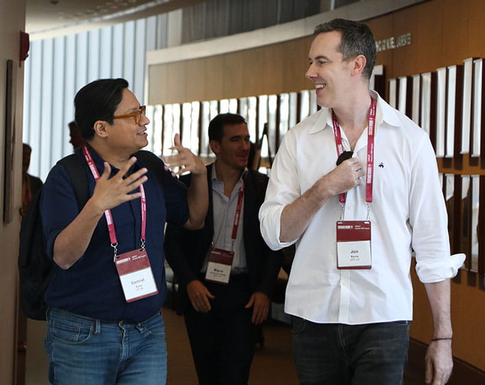 two EMBA students talking to each other while walking