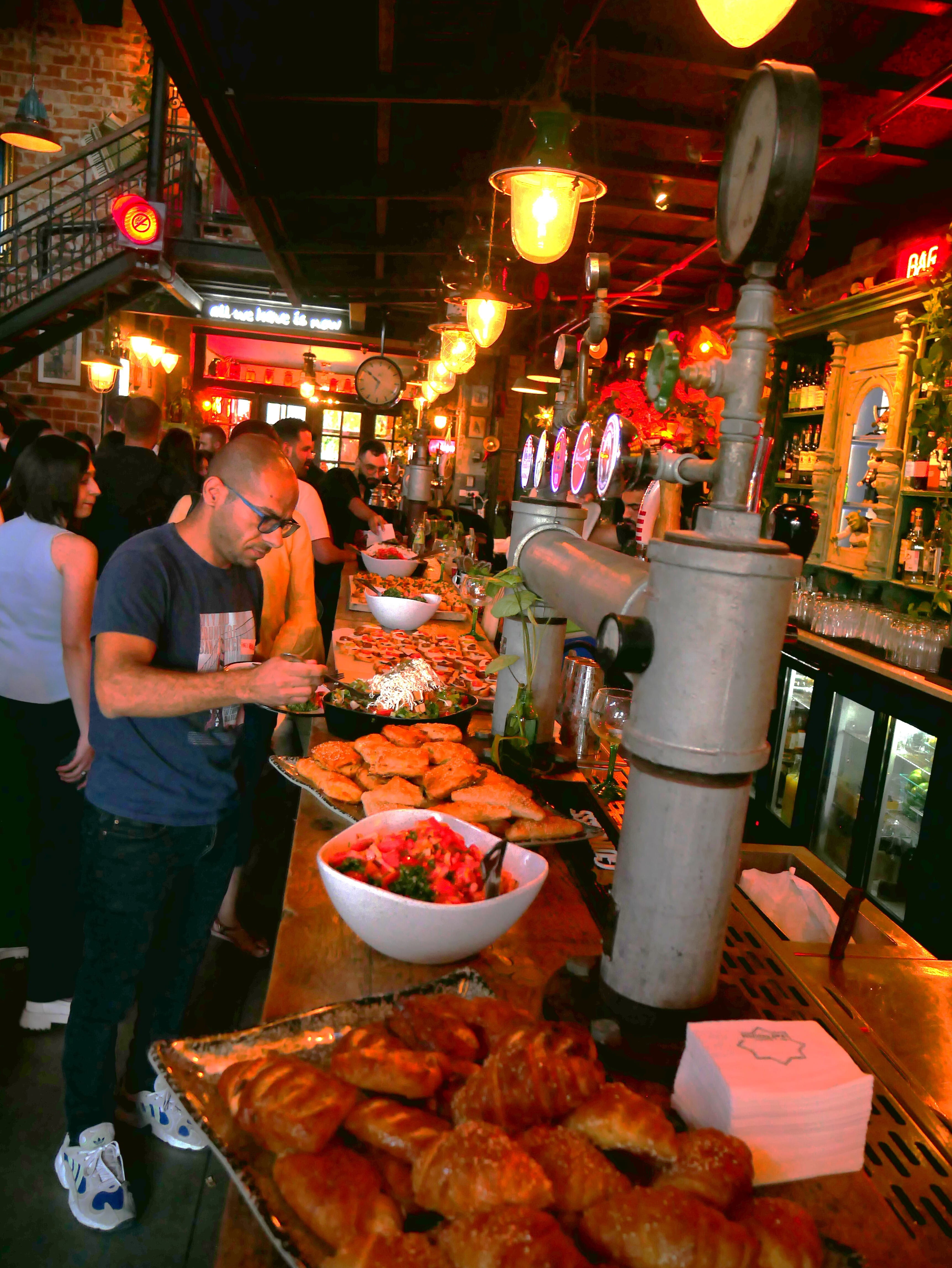 Booth Alum Amir Akleh's event with attendees getting food 