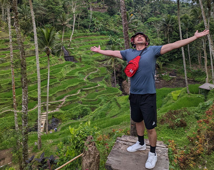 Moises with his arms stretched out in the forest 