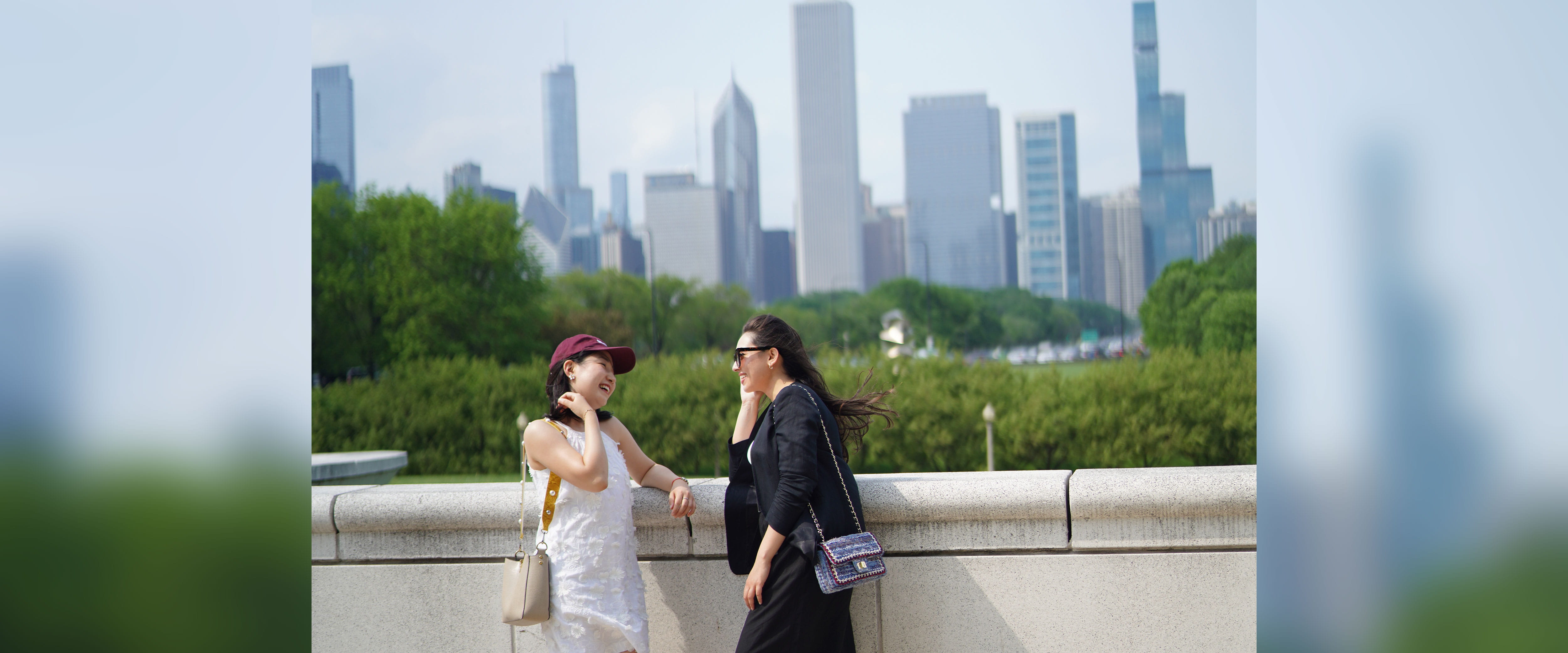 Two women talking and smiling with Chicago skyline in the background