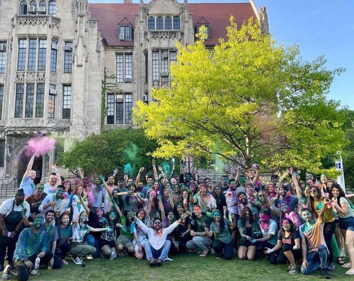 Group of SABG members outside on UChicago campus covered in pink and green paint 