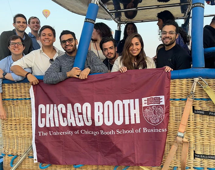 Maria and other Boothies outside holding Booth flag