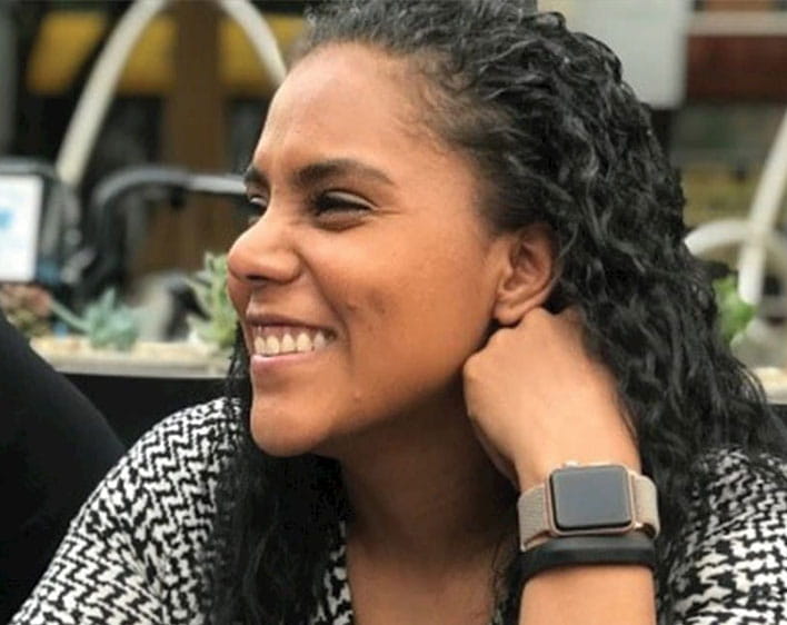 close up of Silvia Medina looking away from camera while smiling