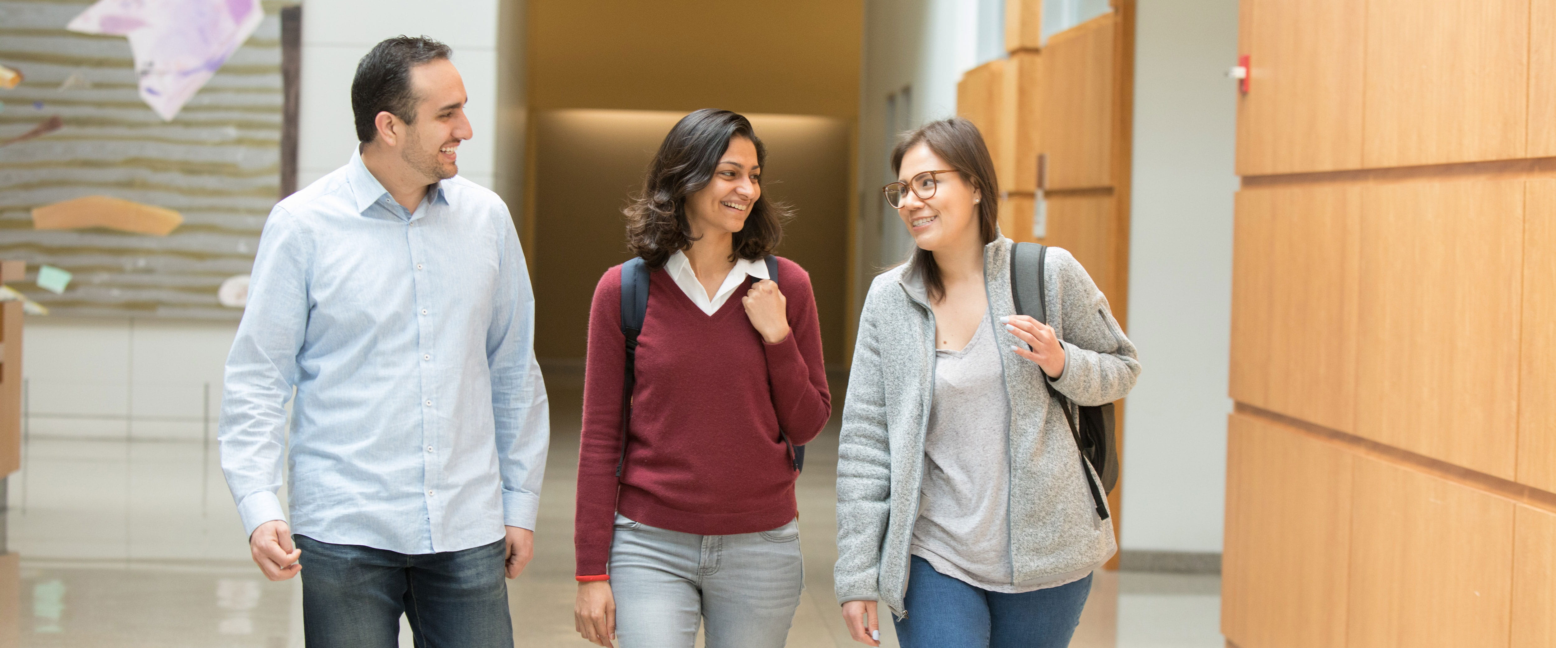 Three students talking in Harper Center