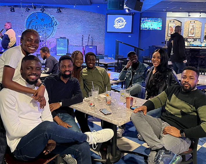 Prince gathered with other members of AAMBAA sitting down at Legends 