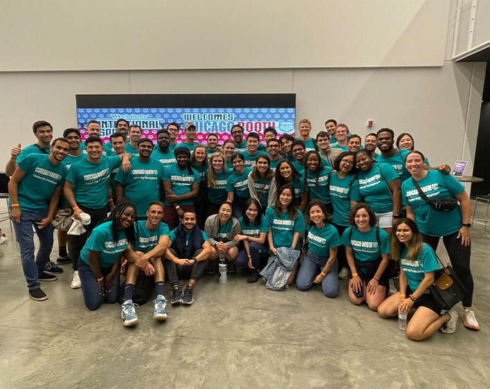 Group of Boothies in matching teal shirts pictured inside