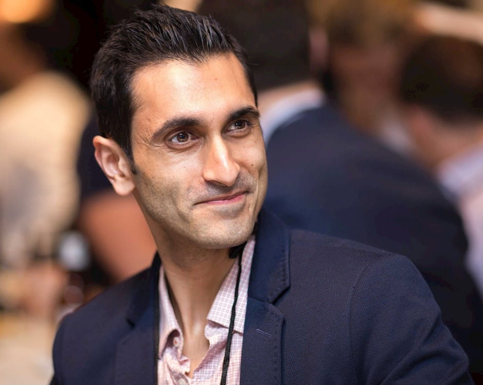 close up of man smirking looking slightly away from camera