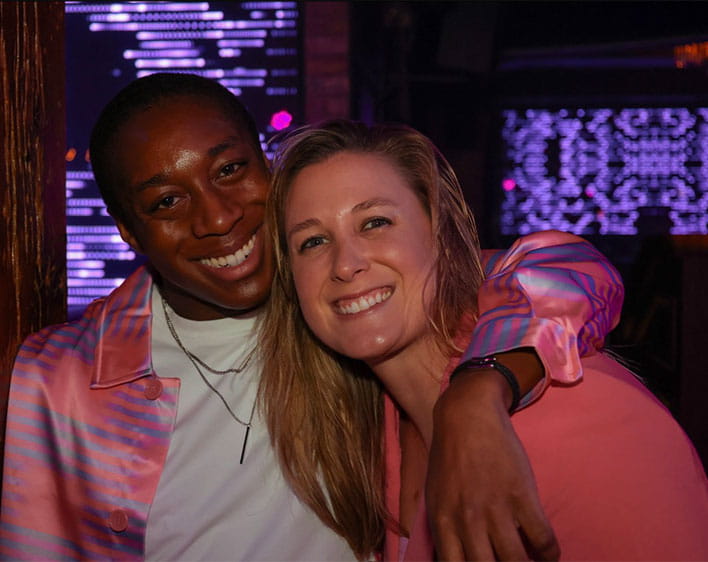 Deasee and another Boothie smiling with Deasee's arm around Boothie