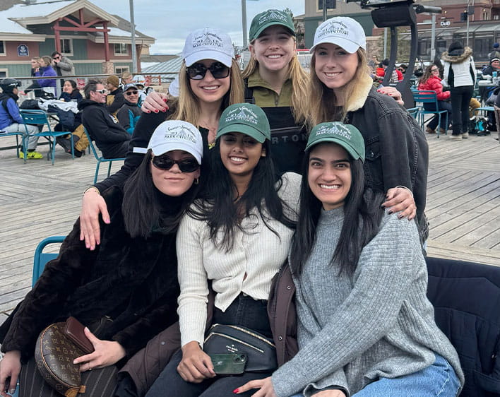 group photo of Emma and five other Boothies smiling