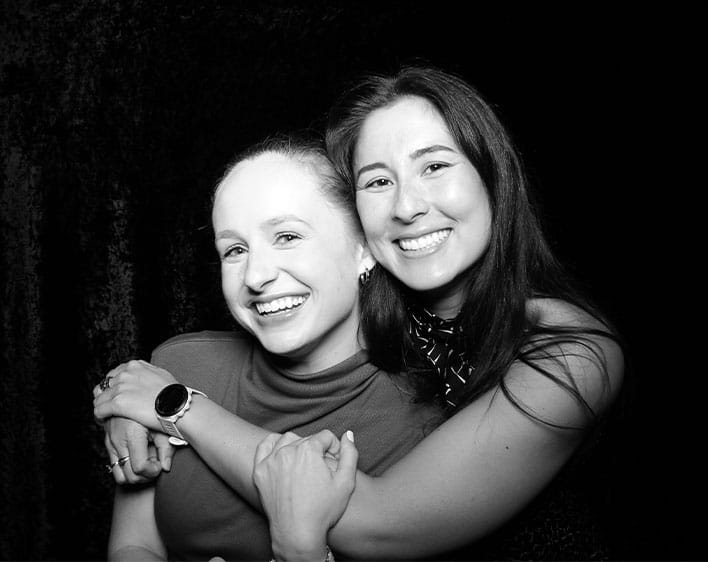 Emma and individual posing together smiling