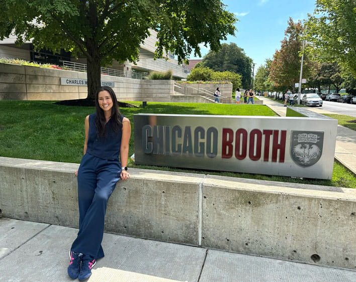 Natalie in front of Chicago Booth sign at the Harper Center