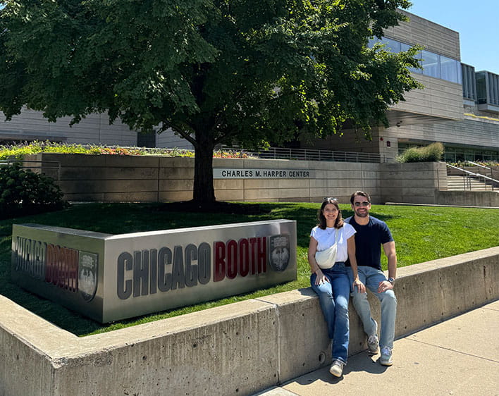 Lud and Gui in front of Chicago Booth sign at Harper Center for Orientation