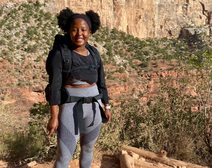 Rimel smiling outdoors in athletic wear