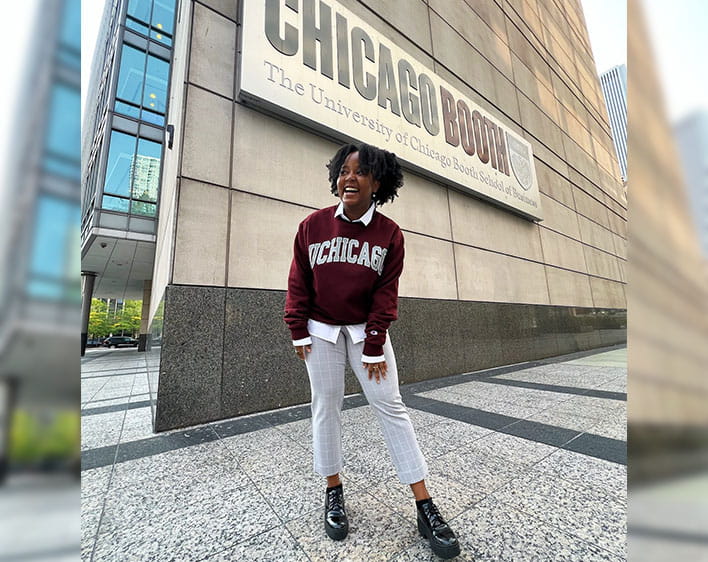Rimel outside of the Gleacher Center smiling in UChicago sweatshirt
