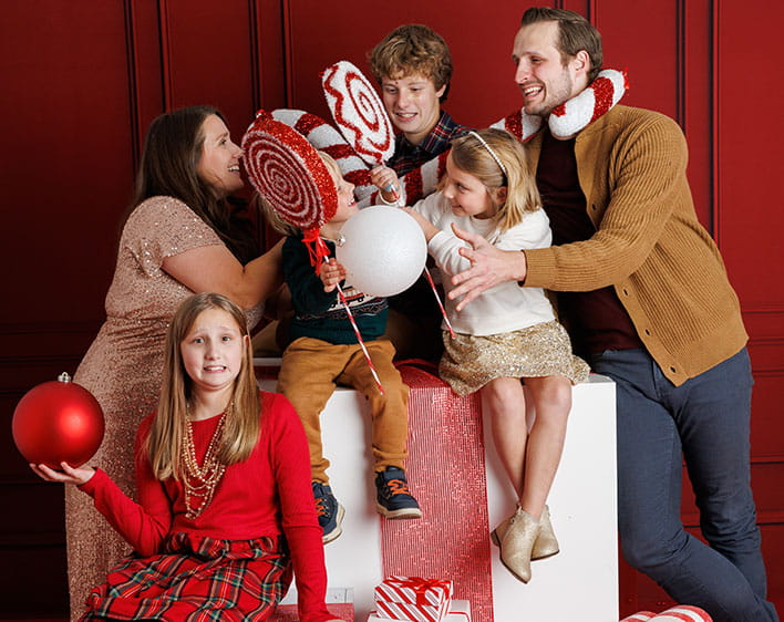 Holiday themed family photo of Aaron with his wife and kids
