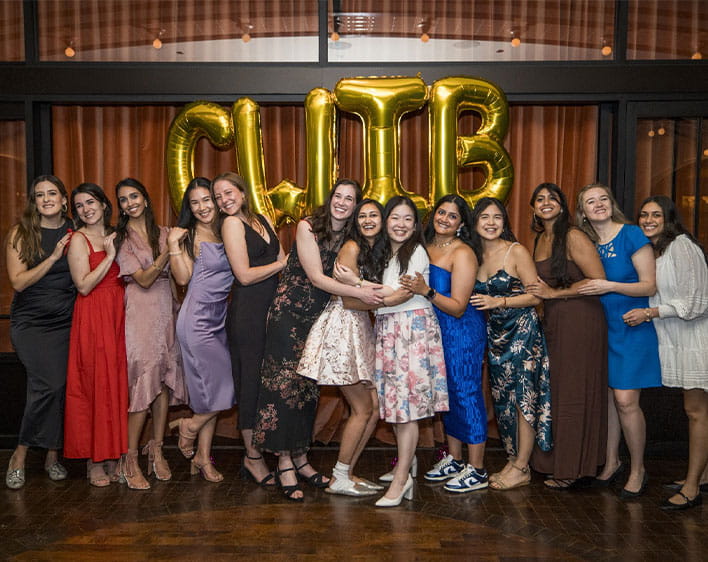 group photo of CWiB members with CWiB balloons in background