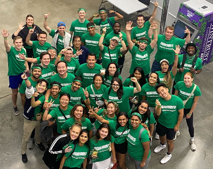 Isha with a group of students in matching green t-shirts