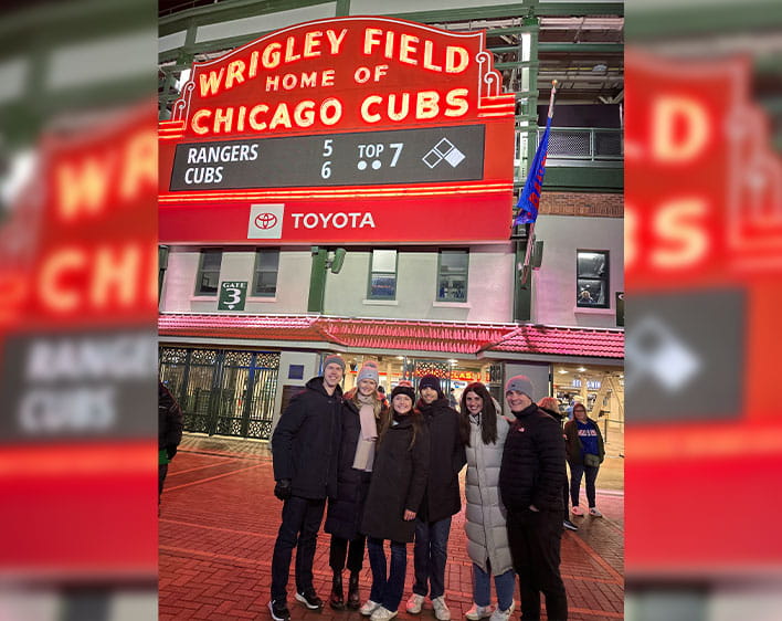 Montgomery, his wife, and friends in front of Wrigley Field sign