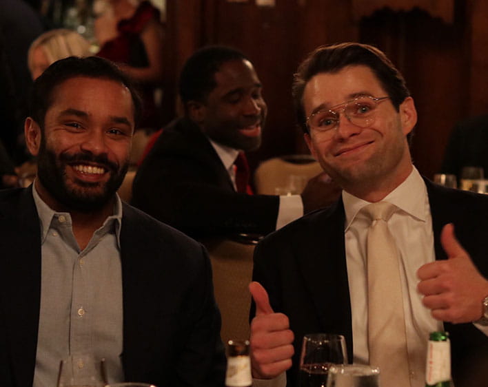 Sai and friend in formal wear at AFG dinner with friend giving thumbs up