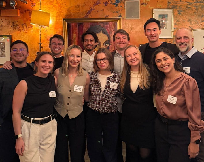 group of 11 people at professional event wearing nametags