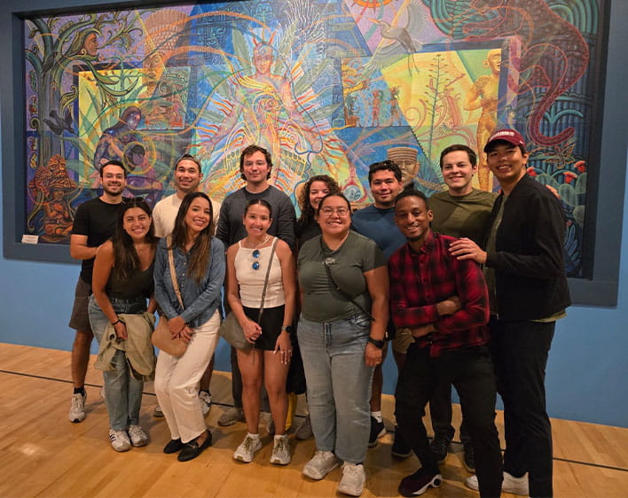 group of students within HABSA student group in front of artwork at the National Musuem of Mexican Art
