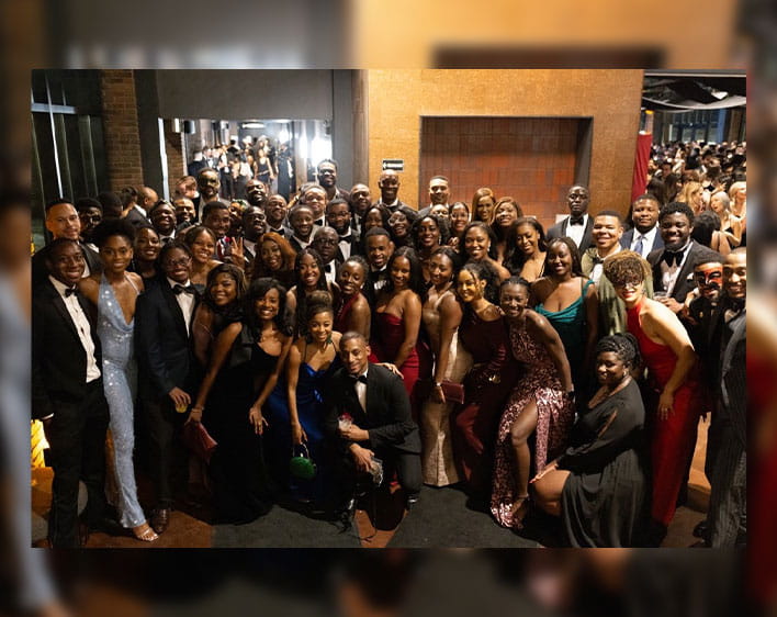 group photo of Boothies in formal gowns and suits