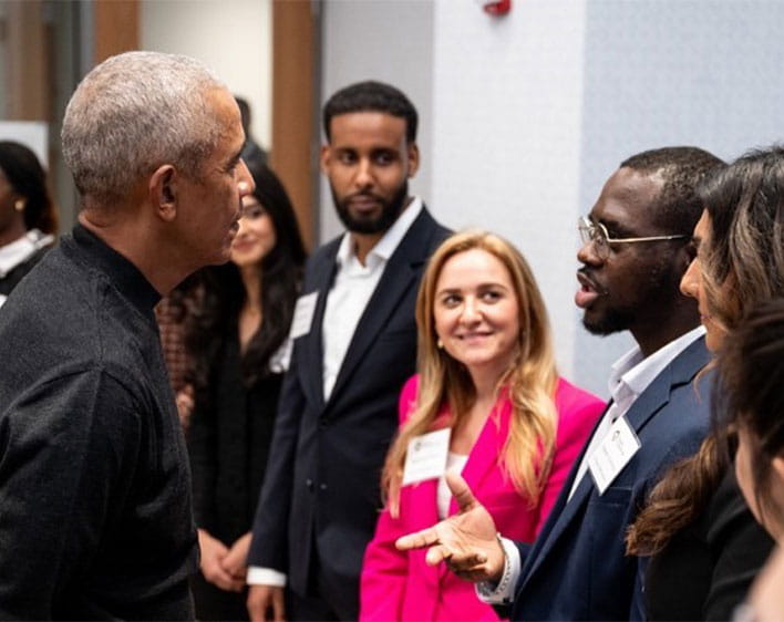 Ope engaging in conversation with President Barack Obama