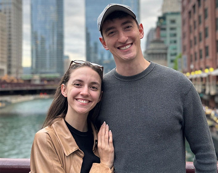 Lorena and Lukas smiling together with downtown Chicago views in the background