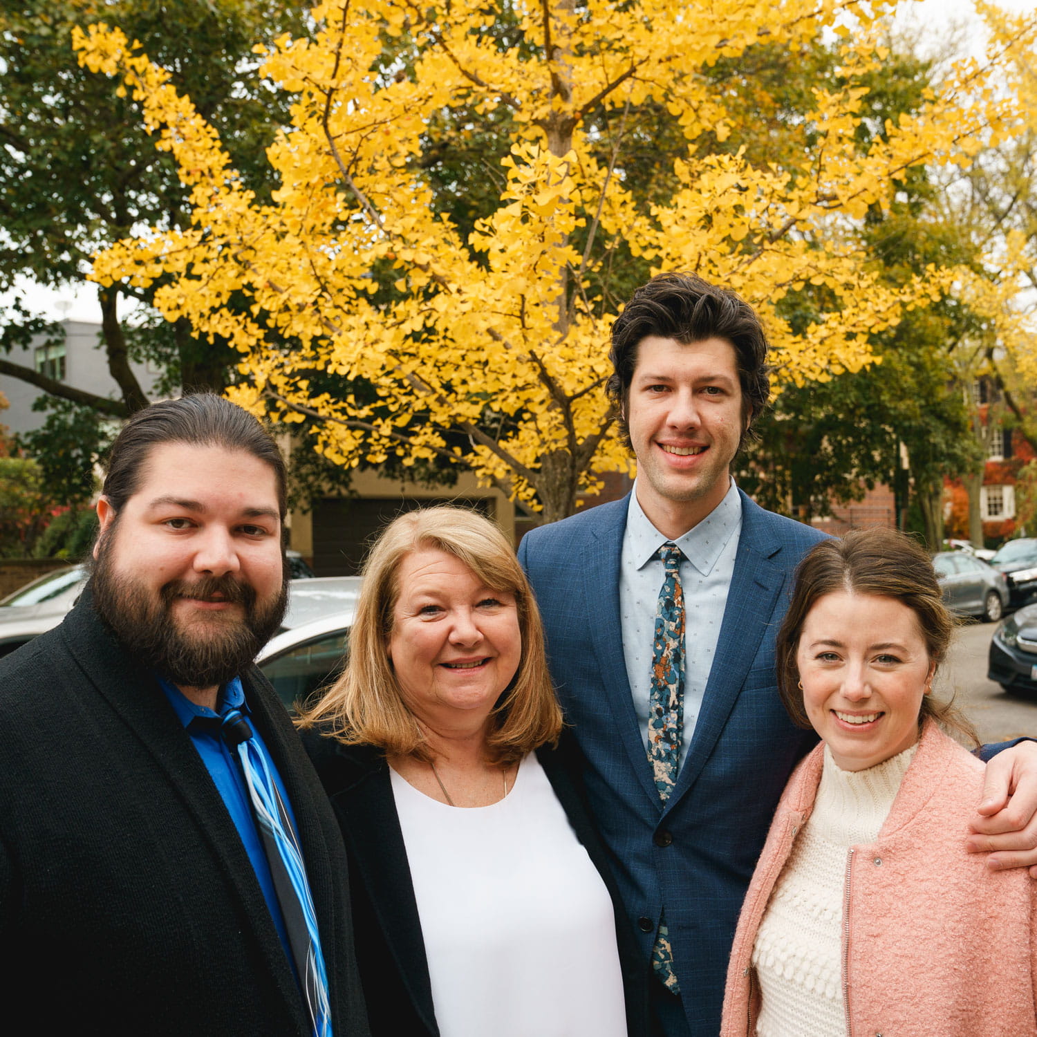 Family members of Tony Gac, former director of facilities at Booth, standing around his memorial tree