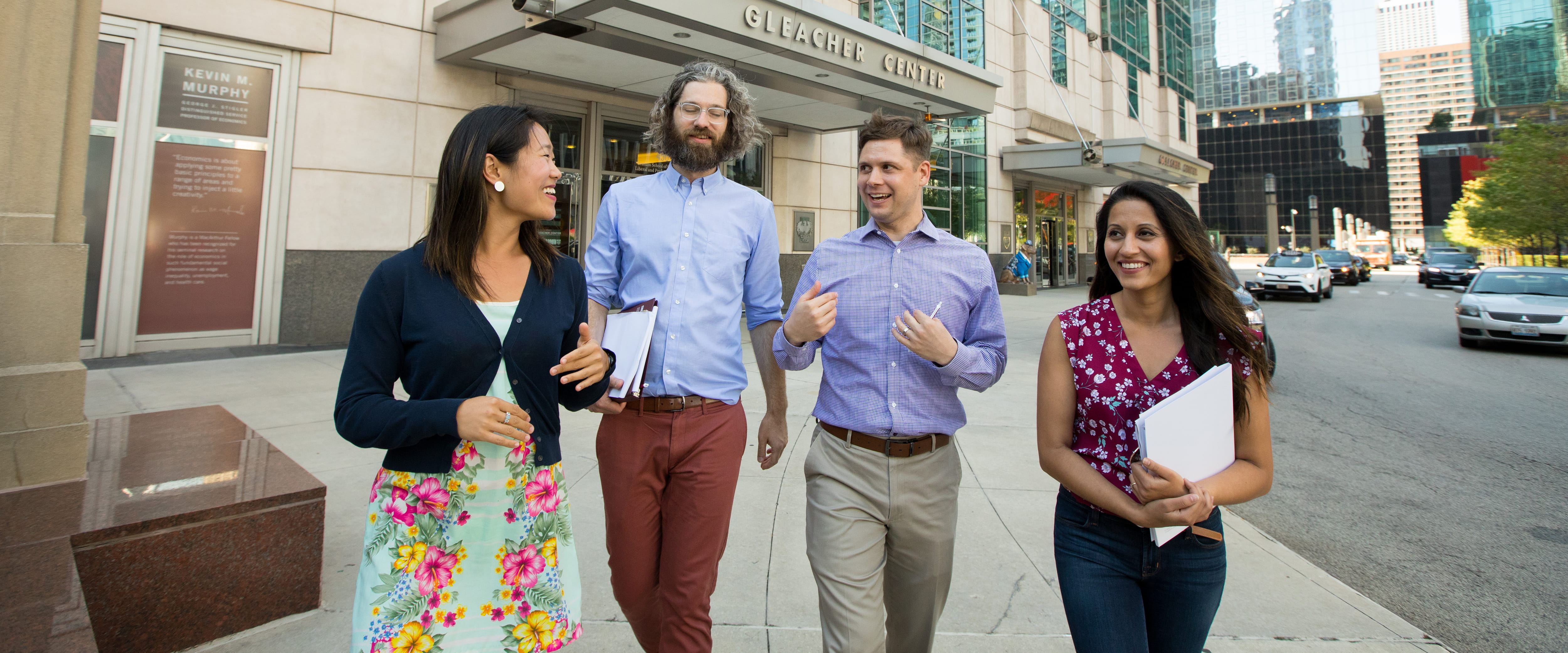 Group of Neubauer Civic Scholars walking outside Gleacher Center