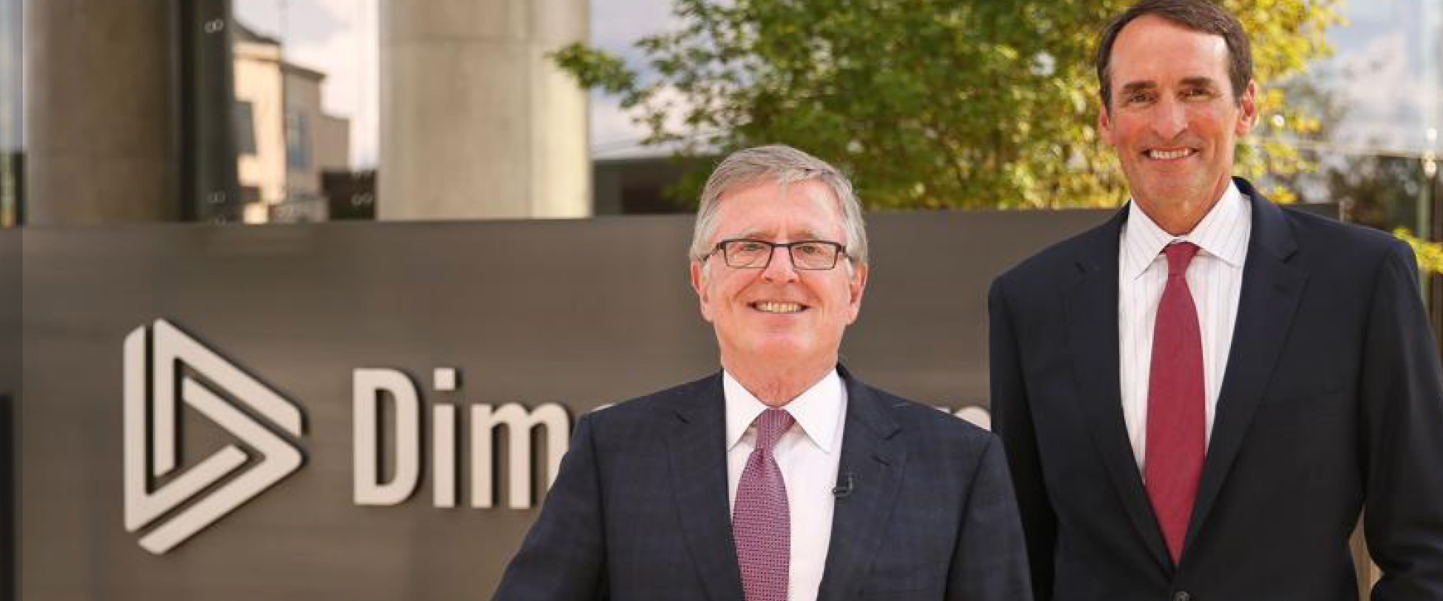 David Booth in front of a Dimensional Fund Advisors sign