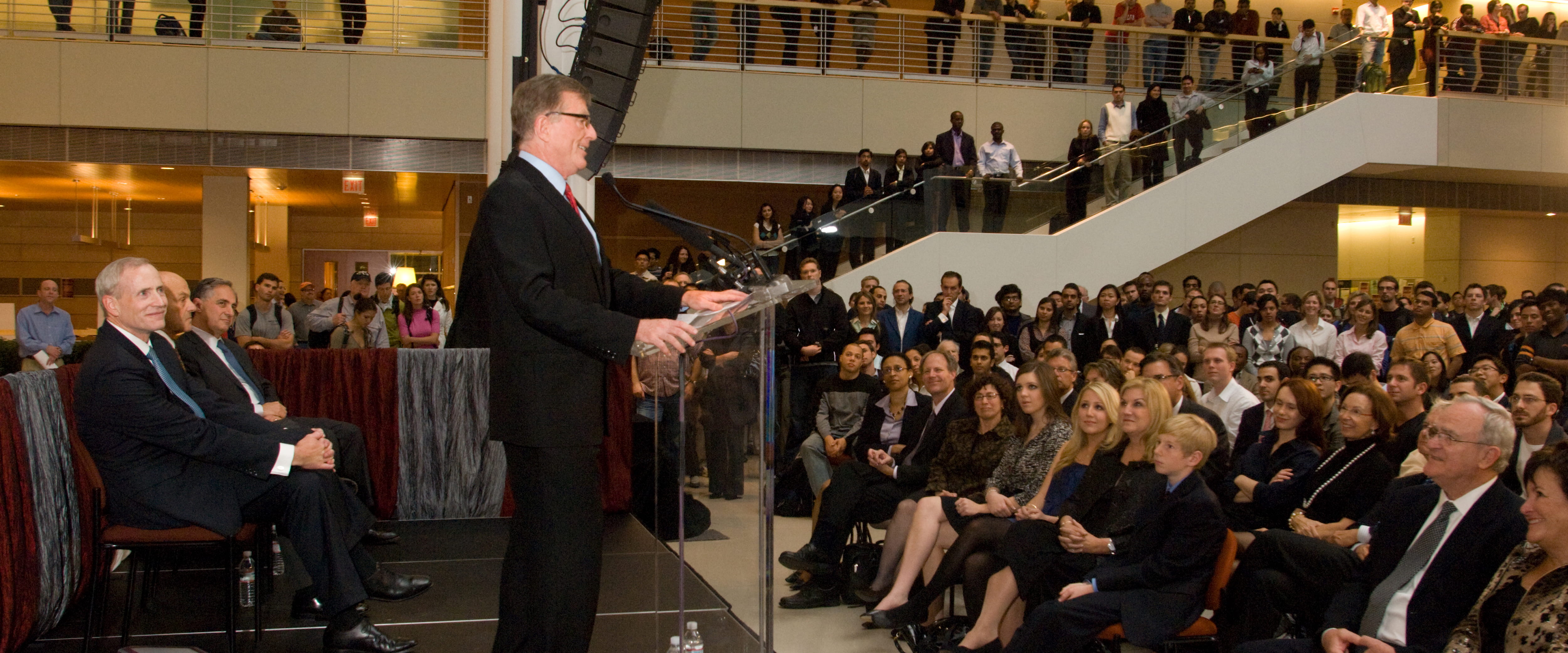David Booth on the dias at the naming presentation in front of a large crowd