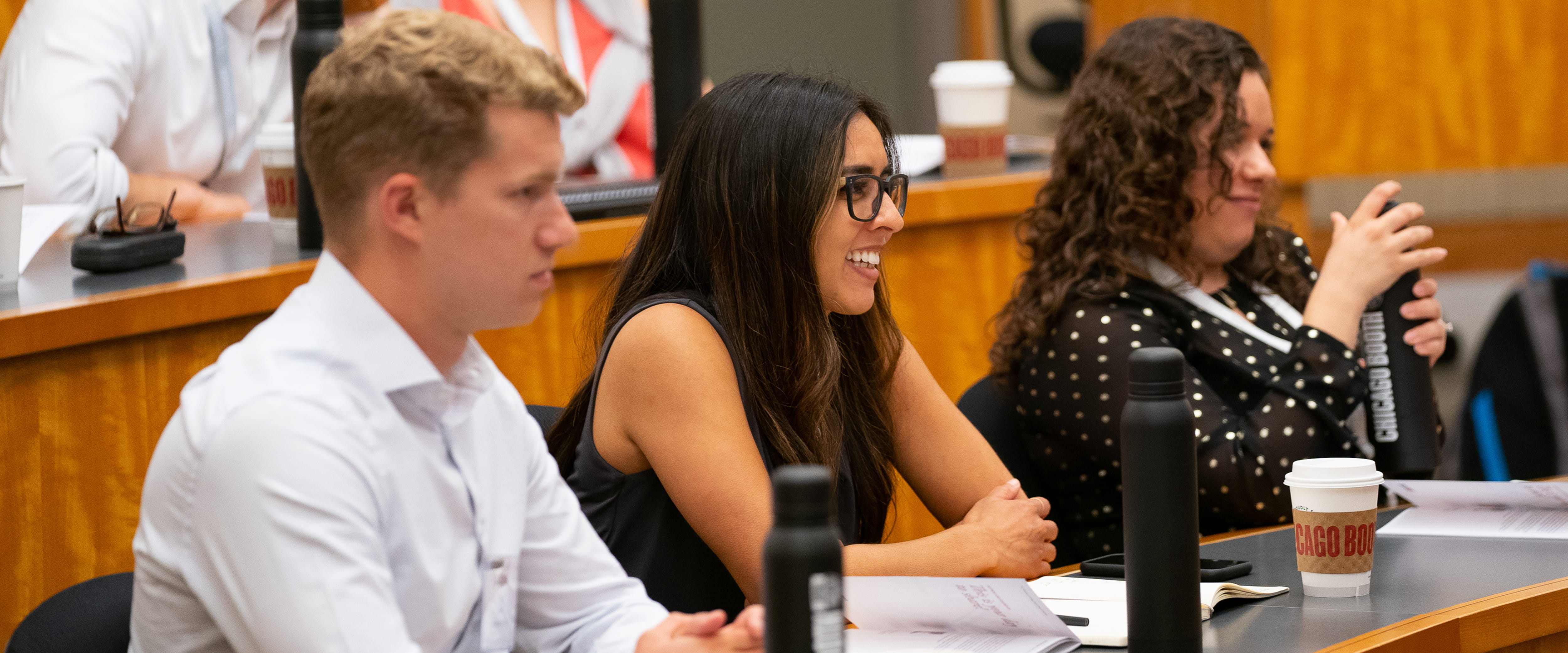 A female student engaged in class, smiling