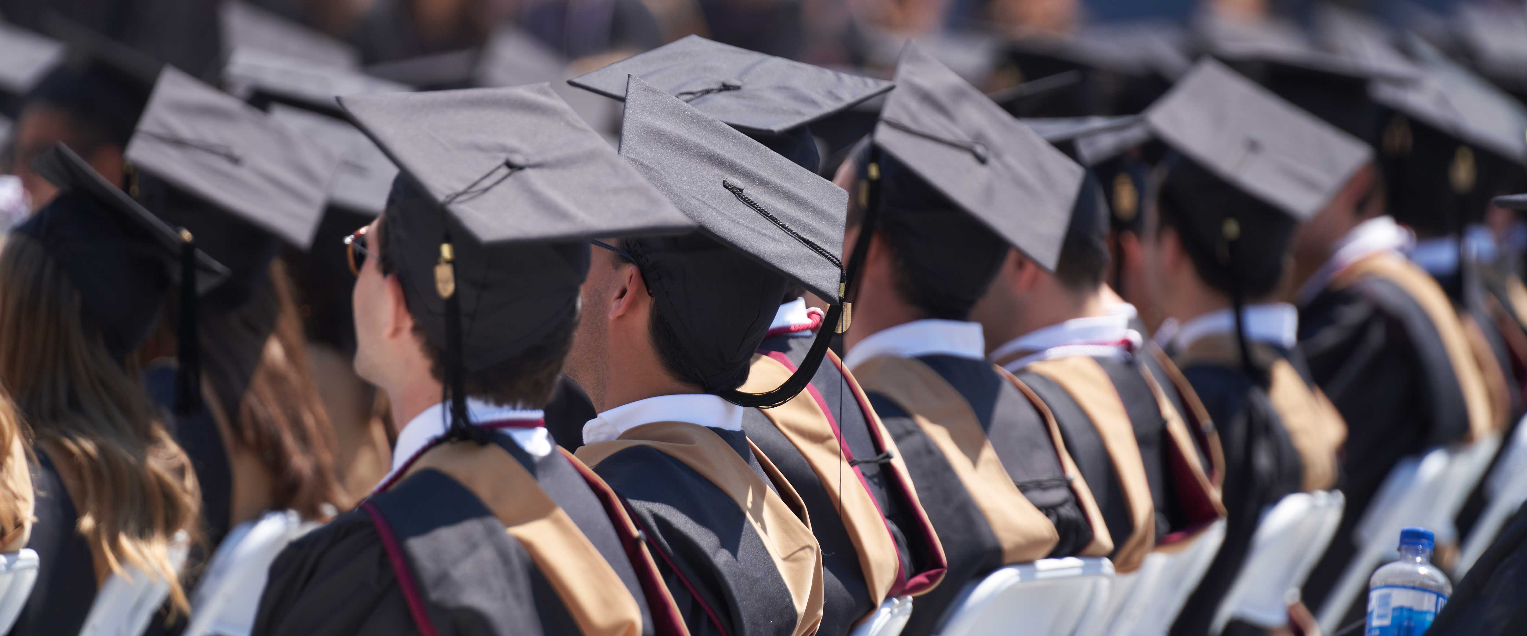 Graduates in caps and gowns seated for convocation ceremony