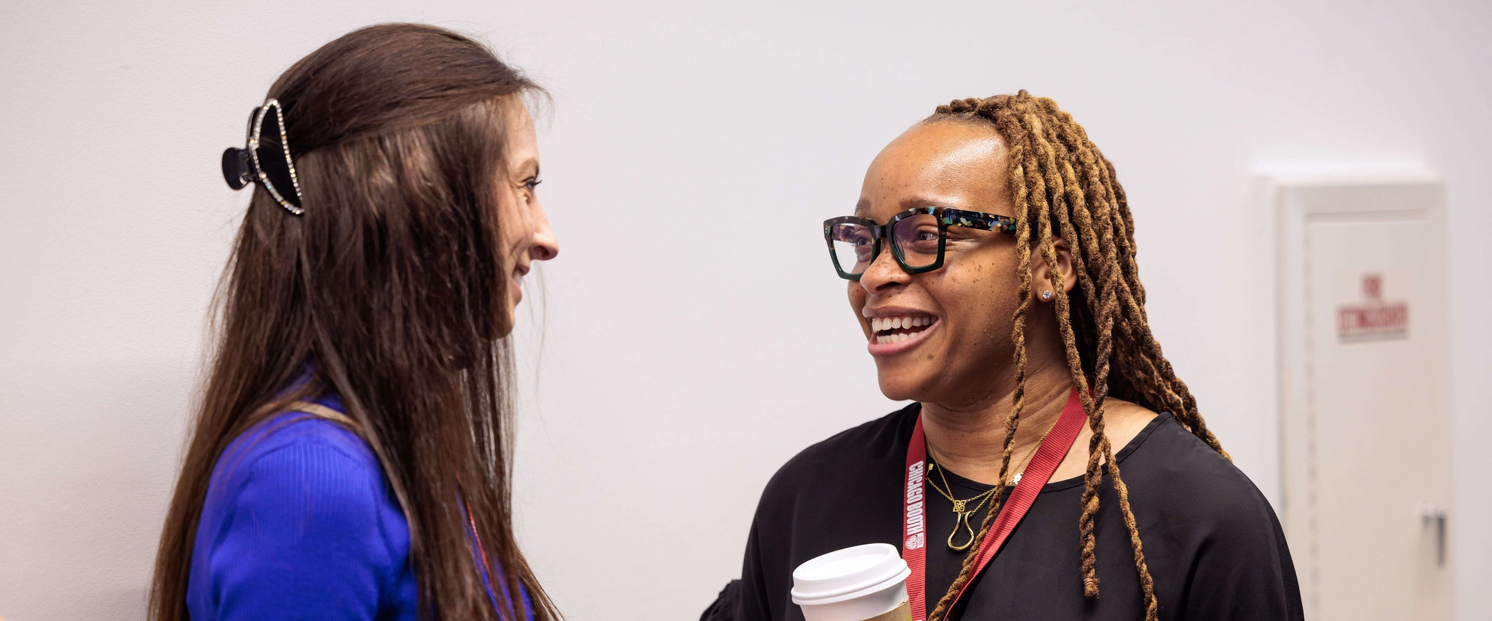 Two women in professional clothing speaking.