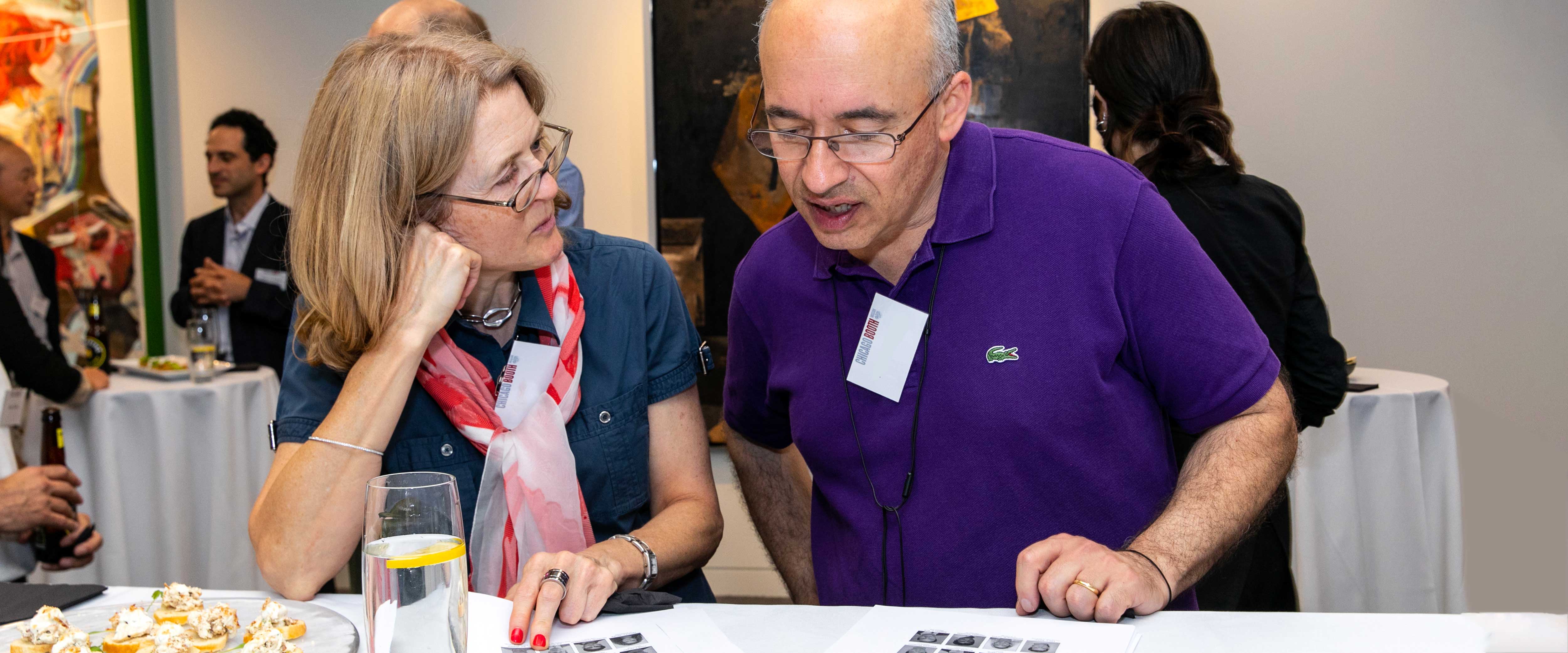 Couple looking at a printout of headshots