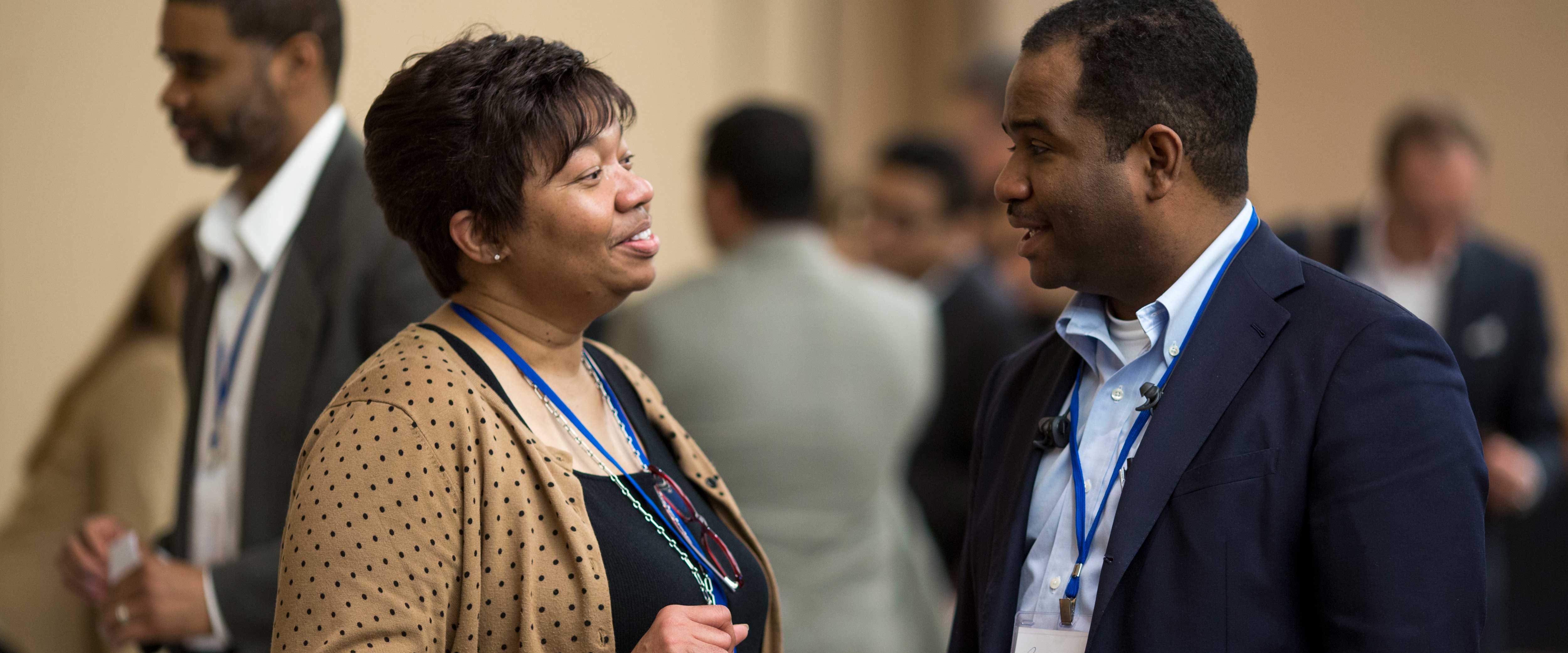 Woman and man speaking at a Chicago Booth event