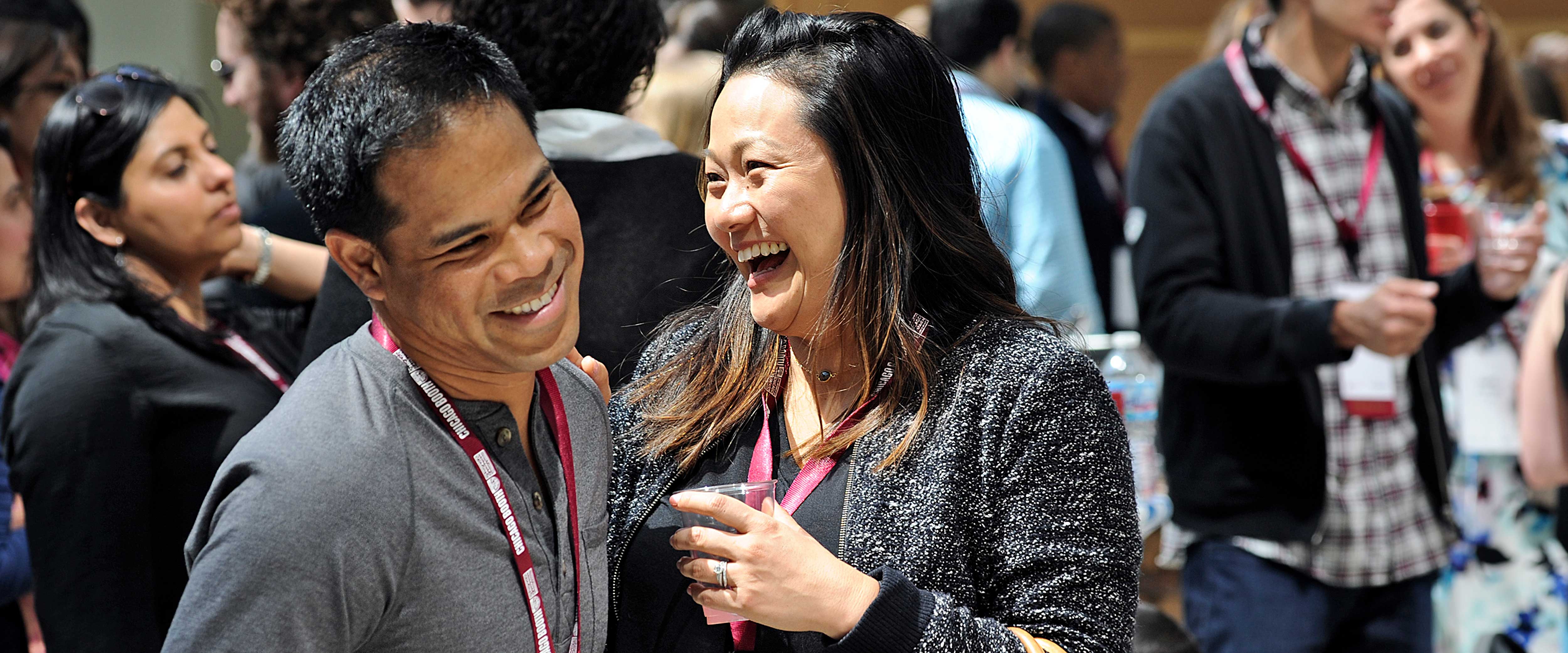 Two friends laughing in the Harper Center winter garden