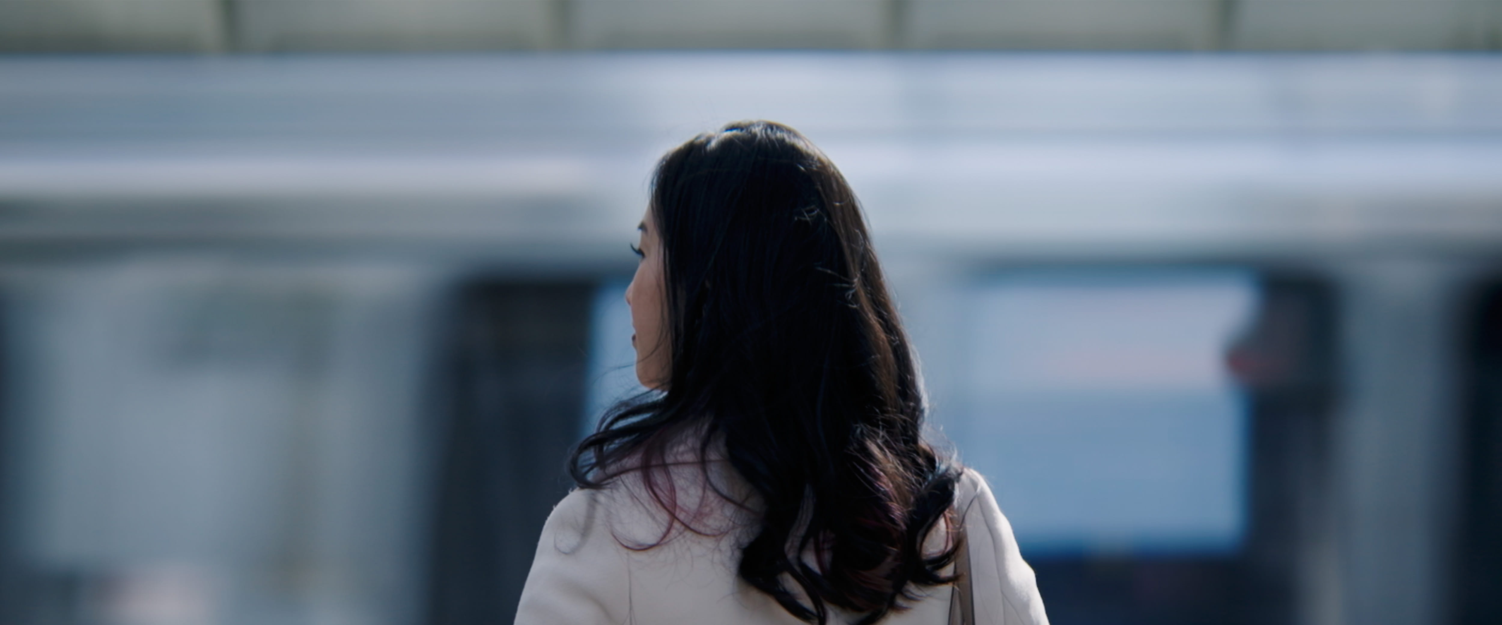 Back of Katrina Bernhardt's head as CTA train passes in background