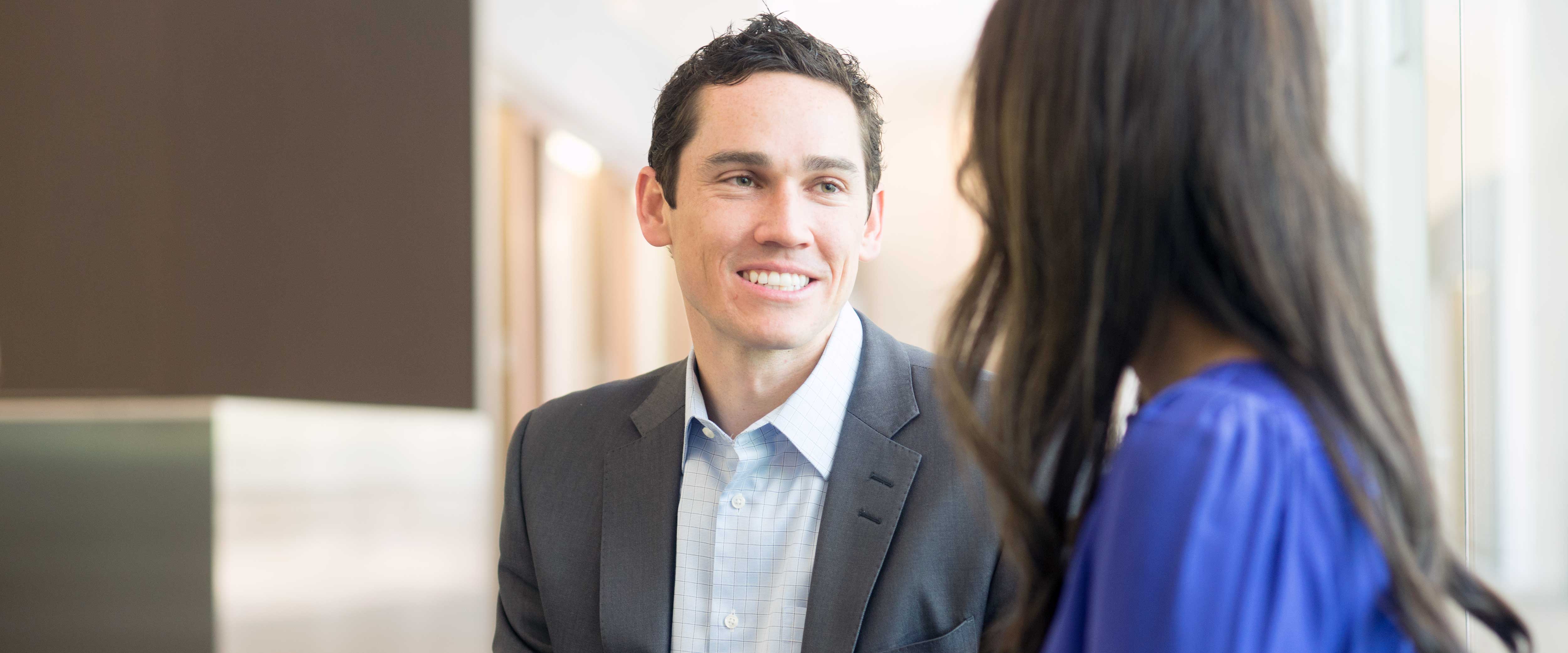 Male and female student sitting talking
