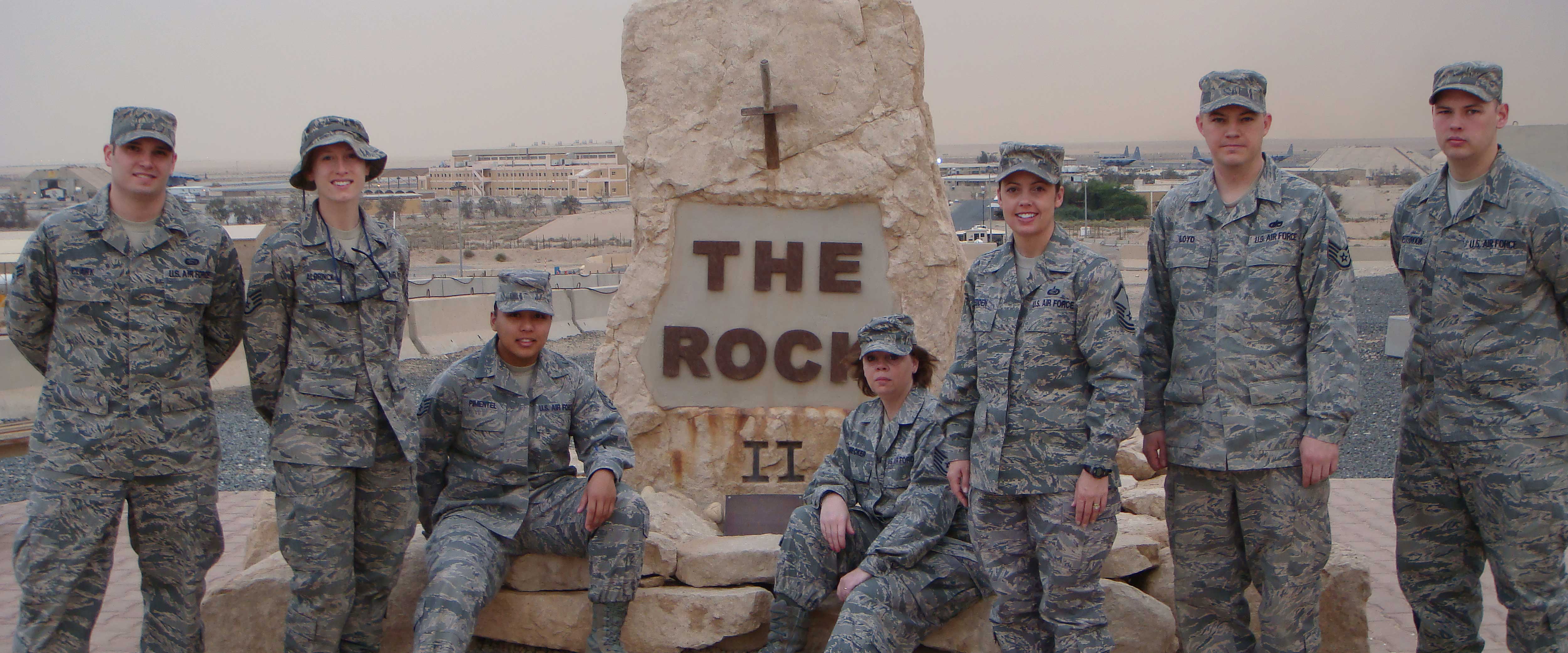 Group shot of military members in front of the Rock