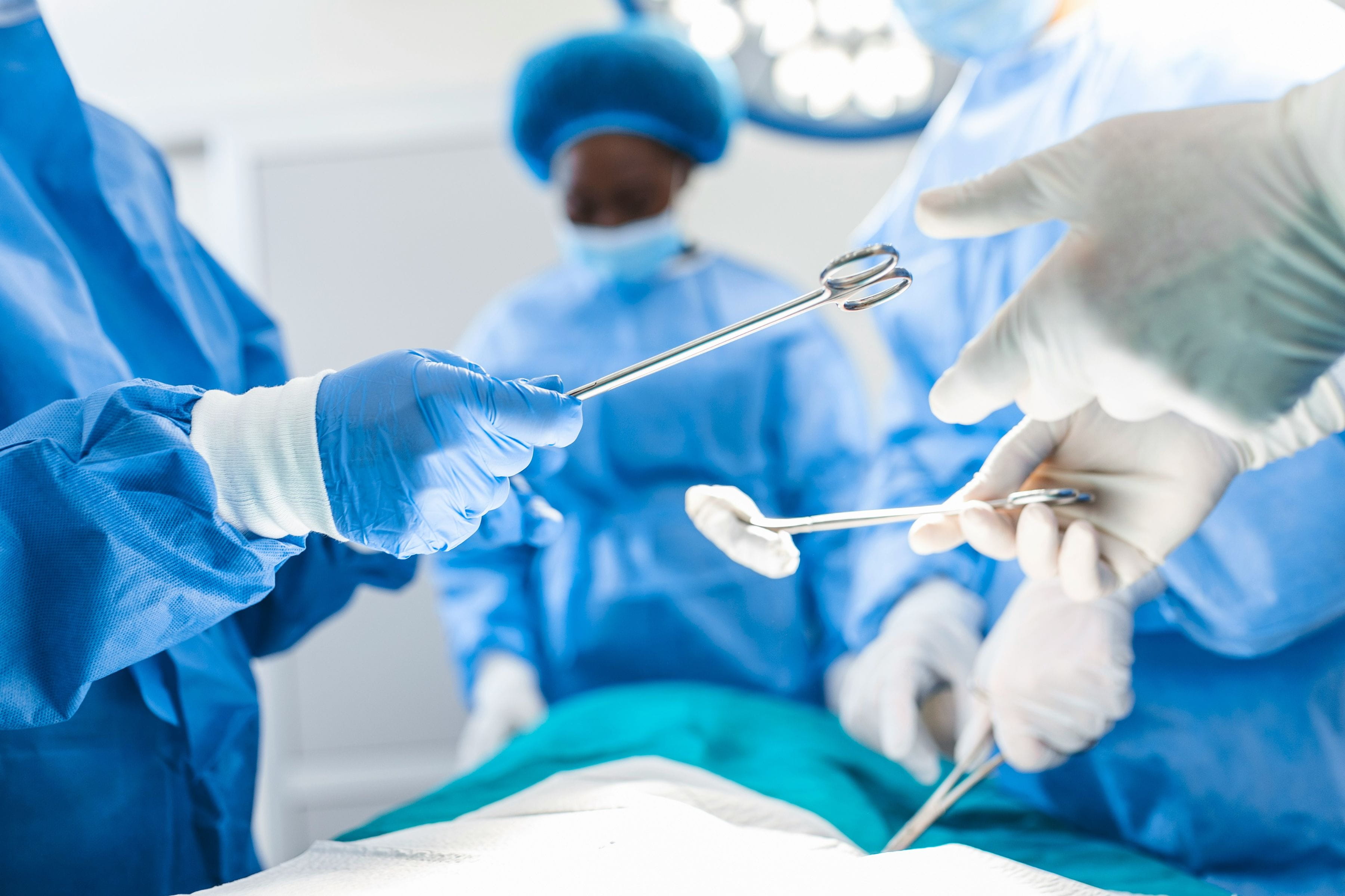 Surgeons and medical staff in operating room with tools